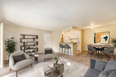 a living room with a couch and chairs and a kitchen with a table